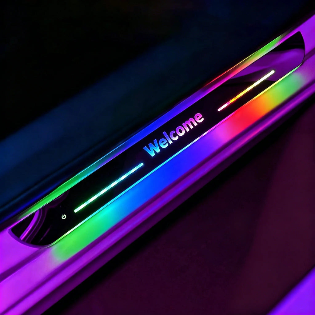 Custom text LED car door sill plate lit up in rainbow colors, showing the word Welcome