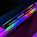 Custom text LED car door sill plate lit up in rainbow colors, showing the word Welcome